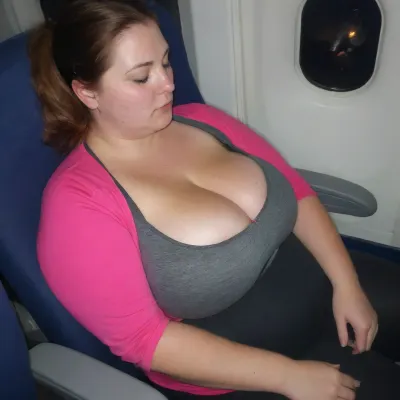 Cute obese brunette 50 yo. sitting in an airplane seat sleeping, chubby face, eyes closed, head tilted back and to the side slightly, highest angle, 3/4 view, bra slightly visible under top, subtle freckles, tight athletic attire, thin active wear, ((slight cleavage:1)), huge boobs, fully clothed, night time, dimly lit, cold, valerymakarenav, <lora:clothed_small:1.1>, <lora:Real_People-SDXL:.8>
