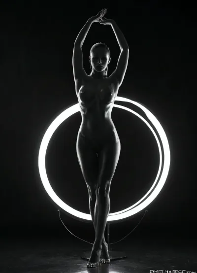 The scene features a striking figure posed elegantly against a deep black backdrop, highlighting the interplay between light and shadow. Central to the composition are two large circular light rings, glowing bright white, which create an arresting visual contrast against the darkness. The figure, whose outline is softly illuminated by the lights, stands sensually within the rings, with arms raised and hands gently gripping the edges, adding to the dynamic nature of the pose. The lighting emanates from the rings, casting subtle shadows that sculpt the contours of the body, emphasizing its form and curves in a way that draws the viewer's eye to the graceful lines. The overall ambiance is both dramatic and intimate, enhanced by the smoky atmosphere that subtly obscures parts of the background and adds depth to the scene. The color palette is monochromatic, dominated by shades of black and white, creating a timeless and elegant aesthetic. This carefully crafted composition, with its bold use of light and shadow, invites the viewer to appreciate the beauty of the human form within a modern, artistic context., ultra detailed, intricate details, cinematic, photorealistic, masterpiece