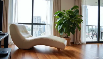 The scene is a high-rise apartment, skyscraper, large floor to ceiling windows, aged mahogany floors, a cream colored leather chaise lounge, a large Epipremnum aureum, money plant, a 75 inch TV is on the wall, a balcony.