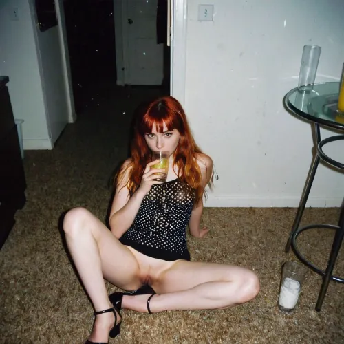 A lone introvert redhead grunge girl with bangs sitting on the floor in a dark corner is visible in the background, captured in grainy film artifacts and analogue film