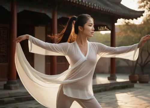 Professional photography, striking photorealism, ultra-detailed, artistic and evocative cinematic aesthetic, a gorgeous young Asian woman, 24 years old, elegant and powerful female kung fu master, beautiful delicate face with sharp refined features, long silky black hair tied in a high ponytail with loose strands gently moving in the wind, serene yet seductive expression, calm intense eyes, wearing a tight-fitting, extremely sheer white Tai Chi uniform made of ultra-thin translucent fabric that clings perfectly to her body, subtle see-through effect revealing the soft curves of her breasts and hard nipples outline, high side slits showing toned legs, elegant and sensual fit, practicing Tai Chi Chuan in a graceful slow movement, standing in the iconic "Holding the Ball" posture, hands perfectly positioned in front of her torso with palms facing each other, relaxed curved fingers with perfect anatomy and spacing, weight elegantly shifted on one leg, beautiful flowing posture full of internal power and femininity, in a secluded ancient Chinese courtyard at golden hour, soft mist floating in the air, weathered stone tiles and old wooden columns in background, warm dramatic golden sunlight casting long soft shadows, gentle breeze moving her hair and sheer fabric, shot on 85mm lens, sharp focus on her face and hands, shallow depth of field softly blurring the background, realistic skin texture with subtle natural glow and sweat, delicate fabric details and sheer effect, film grain, tranquil yet sensual harmony, (extremely sheer translucent white fabric:1.45), (fabric clinging to breasts and curves with visible nipple outline:1.4), (elegant sensual female tai chi master:1.35)