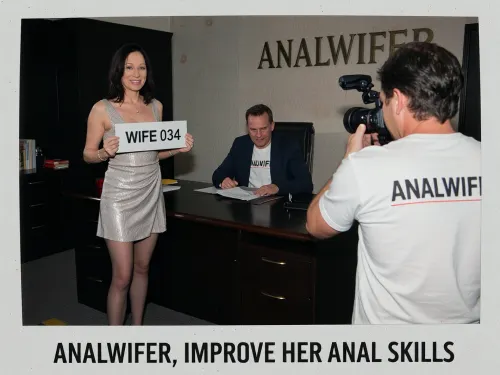 (polaroid vintage photo), Standing upright mature woman holding a sign with two hands that says "WIFE 034" and a company man seated at a big desk in a dark office, a photographer seen from behin is taking pics with a camera, she is standing in the right side of the desk facing the photographer, the word "ANALWIFER" is graved in the wall, exactly written caption at the bottom with arial letters "ANALWIFER, IMPROVE HER ANAL SKILLS", slim, she has dark hair, She is dressed in a elegant sexy everyday dress, stockings, and high heels, she is smiling to photographer, director is seated at desk and is wearing a blazer with a t-shirt underneath that says "ANALWIFER"., He has 50yo with a lot of slightly wavy thick dark hair with a curl over the forehead., (looking to photographer), photographer wears a t-shirt that says "ANALWIFER"., (grandma female 75 years old with sagging skin and medium-lenght straight dark hair), (pale skin), very slim, thin, age wrinkles, (very sagging old skin), Hard, direct, pop-up style frontal camera flash lighting, creating extreme high contrast between brightly lit foreground subjects and a deeply shadowed, dark background. The skin has a distinct glistening, sweaty-look sheen. Rapid fall-off of light into chaos and darkness in the distance. Retro flash color rendering with harsh highlights and potential red-eye effect.