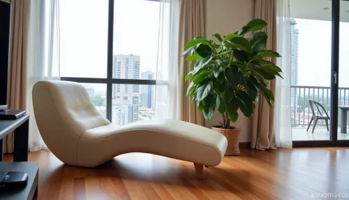 The scene is a high-rise apartment, skyscraper, large floor to ceiling windows, aged mahogany floors, a cream colored leather chaise lounge, a large Epipremnum aureum, money plant, a 75 inch TV is on the wall, a balcony.