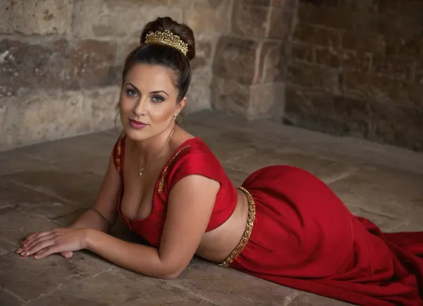(4K UHD ultra-detailed RAW photo), high detailed, 8k, (photorealistic:1.7), fit 1women 50 yo, lying on stomach, ((milf:1.5)), ((in elegant red Roman tunic with gold embroidery)), ((gold and ruby ​​​​jewelry)), ((detailed high ponytail hairstyle)), 1/2 length view, ((sad:1.5)), (makeup:1.3), ((ass up)), ((in the Roman palace, detailed background)), (4K, high resolution, best quality), plump, skindentation, chubby, bbw, venus, big, ass, tiedtobed, face, up, down, frontal, at, angle, close, rope, black, white, laying, on, stomach, <lora:Chubby BBW - XL:.5>, <lora:add-detail-xl:.5>, <lora:woman_laying_on_stomach_xl_lora_reg-000027:.5>, Photography, stvmccrr, style, <lora:stvmccrr:.8>