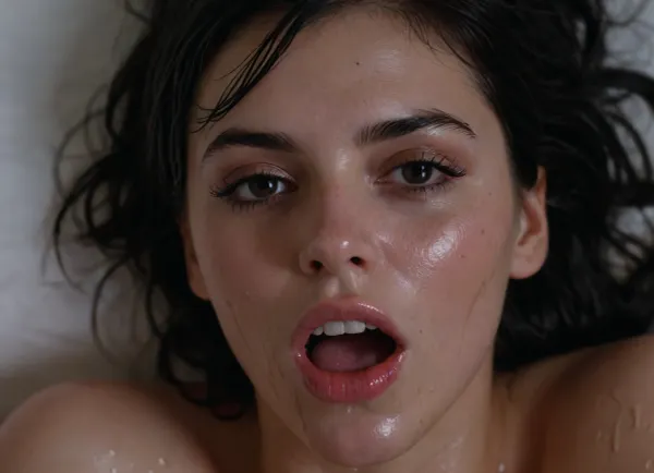 cute young cumslut lying on the bed, dark black hair, wet hair sweaty skin, running mascara, smeared makeup, all of her body and face is covered in semen, on her face, in her mouth, on her tongue