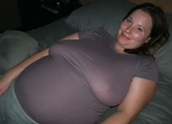 Amateur candid photo, old fat bbw 41yo, brown hair, laying in bed, dark bedroom, wearing white-grey sweatpant pjs and a tight form-fitting tshirt, (braless, pokies), small flirty smile, ultimate realism, poor lighting, at night, dark, night, realistic detailed skin texture, focus on realistic face, pale white skin, braless, Wearing, clothes, that, make, sense, with, Braless>, sagging, breasts, megachubsdxl, morbidly, obese, <lora:bralessSDXL_v1_00022:1.5>, <lora:sagging-000015:.8>, <lora:megachubsdxl_13:.4>