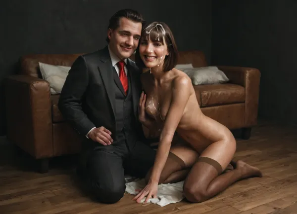 (ultra realistic, ultra detailed, best quality, realistic style, soft shadows, soft light, cinematic), (black room, wood floor, white towel on the floor, brown leather sofa), wife and husband, (skinny brunette mature wife, 40 yo, (dark medium-length bob hair with bangs), (beautiful thin narrow triangular face, narrow long nose, feint small amount of freckles across nose, thin narrow lips, dark gray eyes, no makeup), (short petite skinny body, (skinny:1.3)), (natural small flat sagging tits, dark stiff protruding nipples, medium halos), short skinny legs, wide thigh gap, skinny flat ass, skinny hips, (she has trimmed pubic hair:1.3), slightly tanned skin, no tattoos), (brown stockings:1.7), smiling, laughing, (cum on her hair:1.9), (cum on her breast:1.9), (facial:1.9), she turned head to the husband, she looks to the husband, (fat husband, 50 years old wearing in black suit, white shirt, red tie, shaved face, short dark hair), (realistic faces:1.3), (perfect face:1.3), (perfect eyes:1.3), perfect hands, realistic detailed eyes, (realistic mature skin texture:1.3)