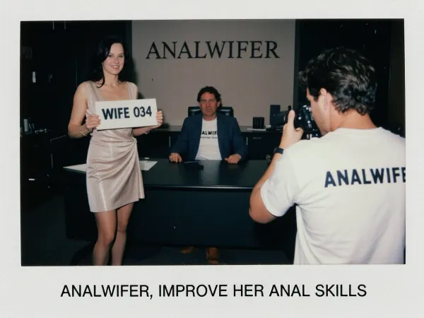 (polaroid vintage photo), Standing upright mature woman holding a sign with two hands that says "WIFE 034" and a company man seated at a big desk in a dark office, a photographer seen from behin is taking pics with a camera, she is standing in the right side of the desk facing the photographer, the word "ANALWIFER" is graved in the wall, exactly written caption at the bottom with arial letters "ANALWIFER, IMPROVE HER ANAL SKILLS", slim, she has dark hair, She is dressed in a elegant sexy everyday dress, stockings, and high heels, she is smiling to photographer, the director is seated at desk and is wearing a blazer with a t-shirt underneath that says "ANALWIFER"., He has a lot of slightly wavy thick dark hair with a curl over the forehead., (looking to photographer), photographer wears a t-shirt that says "ANALWIFER"., (grandma female 75 years old with sagging skin and medium-lenght straight dark hair), (pale skin), very slim, thin, age wrinkles, (very sagging old skin), Hard, direct, pop-up style frontal camera flash lighting, creating extreme high contrast between brightly lit foreground subjects and a deeply shadowed, dark background. The skin has a distinct glistening, sweaty-look sheen. Rapid fall-off of light into chaos and darkness in the distance. Retro flash color rendering with harsh highlights and potential red-eye effect.