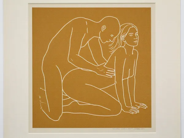 minimalist contemporary figurative screen print, square mustard ochre field centered on a slightly larger pale off white sheet of paper, perfectly frontal reproduction as though photographing a framed or unframed art print straight on, two clearly adult figures, approximately 30 years old, represented exclusively by sparse continuous off white contour lines, intimate but non graphic physical interaction, adult woman positioned on the right in a kneeling all fours pose, knees resting toward the lower center, lower legs extending backward toward the left, arms straight and supporting her upper body, hands placed near the lower right corner, torso gently arched upward, head lifted and turned slightly upward toward the right, long hair suggested with three or four sweeping white lines, second adult figure positioned immediately behind and slightly above her on the left, kneeling upright with torso leaning gently forward, head lowered toward her, arms reaching toward her waist and hips, figures communicating closeness through posture without explicit anatomical detail, facial features reduced to tiny economical marks, absolutely no realistic skin, no shading and no internal modeling, lines approximately uniform in thickness with occasional hand drawn irregularity, muted mustard yellow ochre background with subtle screen print texture, warm ivory white linework, large calm areas of untouched color surrounding the figures, composition centered slightly below the vertical midpoint, recognizable human anatomy simplified into elegant flowing contours, late twentieth century graphic art aesthetic, restrained provocative museum print character, thin pale paper border visible around the mustard square, tiny nearly illegible artist signature near the lower right margin, soft neutral ambient illumination, slight paper texture, perfectly square presentation.