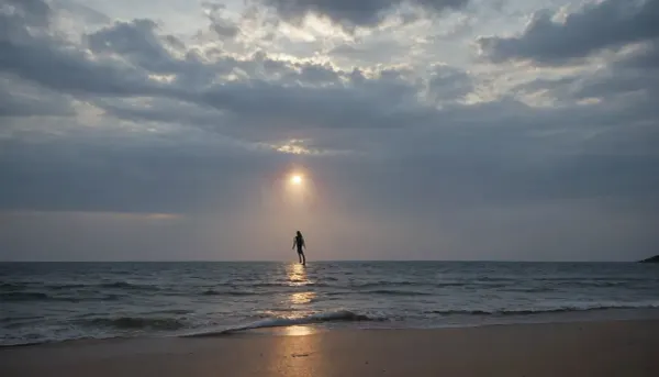 Create a breathtaking ultra-photorealistic fine-art photograph at night on the edge of a perfectly calm black ocean. There is no visible artificial lighting. The primary illumination comes from moonlight reflected from the surface of the ocean below the camera's subject, creating a rare and surreal upward light effect. The reflected moonlight is fragmented by tiny moving waves and water caustics, projecting constantly shifting ribbons of silver, pale blue, pearl-white and faint spectral color upward onto the human subject and the surrounding environment. The light appears to come from the ocean itself. The subject stands barefoot at the edge of the water, surrounded by darkness. Their body is illuminated from below by trembling liquid reflections while a very weak natural moonlight rim outlines the shoulders, hair and silhouette from above. This creates an extraordinary contradiction, darkness above, light below, and the human body suspended between two different worlds. Every reflection must behave like real water-caustic illumination. Project thousands of tiny moving patterns across the skin, fragmented silver lines, soft ripples, liquid geometric distortions, tiny luminous wavelets, broken crescents, and delicate spectral interference patterns. The reflected light interacts naturally with skin texture. Reveal pores. Fine hairs. Tiny imperfections. Moisture. Subtle skin translucency. Muscle contours. Natural anatomical structure. Wet skin should catch the reflected moonlight differently from dry skin. Water droplets on the body should act as miniature lenses, producing tiny distorted reflections and microscopic highlights. The ocean itself should remain extremely dark, almost black, except for the broken path of reflected moonlight stretching toward the horizon. The moon should NOT dominate the image. The reflection is the star. Add thin atmospheric mist close to the water surface. Inside the mist, tiny airborne droplets catch fragments of reflected moonlight, creating a barely visible luminous atmosphere. Far in the background, distant clouds partially obscure the moon. Through the clouds, create extremely subtle silver halos and atmospheric scattering. Occasionally introduce very faint natural bioluminescence in the shallow water around the subject's feet, appearing as tiny cyan-blue points disturbed by movement. The bioluminescence must remain secondary and sparse. Do not turn the scene into fantasy lighting. The image must remain believable as an extraordinary long-exposure photograph of a rare lighting condition. Use an elite full-frame professional camera. 85mm cinematic portrait lens, extremely high dynamic range, exceptional shadow retention, natural highlight roll-off, precise focus on the subject, gradual focus falloff toward the water, realistic lens compression, subtle lens imperfections, natural bokeh, realistic diffraction, delicate film grain, authentic sensor characteristics, extremely subtle halation