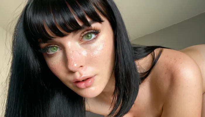 A photorealistic portrait of a young woman with striking light green eyes and thick, dark eyelashes. Her black hair is styled with soft bangs framing her face, which is lightly freckled and has delicate, well-defined facial features. She has smooth, light-toned skin with subtle texture and natural lighting enhancing her flawless complexion. Her lips are glossy, and her black eyeliner accentuates her expressive gaze. She has a tight, toned body with medium-sized breasts, depicted in a natural yet slightly posed stance. The soft lighting creates a warm, intimate atmosphere with neutral tones, emphasizing the ultra-detailed textures of her skin, and makeup. The image is a hyper-realistic masterpiece, capturing the essence of an e-girl aesthetic with subtle sensuality., <lora:Flux.Soogsx-step00000450:.8>, pussy, labia, clitoris, big, open, spread, closed, small, medium, large, long, shaved, pubic, hair, bad, lighting, bright, <lora:PinkPussy_v0:.5>, 1-alpha, .8>