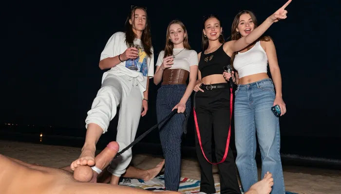 4 nerdy girls, 18 years old gen-z amateurs, lesbians, at sleepover party, first girl wearing casual sweatpants and oversized tshirt, second girl wearing fashionable pants and corset, third girl wearing casual wide pants and tank top, (facing viewer), she points her finger ahead, footjob, feet stomping his dick, tied dick, dick torture, cbt, tied balls, one foot on his penis, dick bondage, tied genitals, femdom, sadistic, view from below, pov, she stand on his dick, they on beach on blanket, they standing, one girl holds glass of vine, second girl holds whip, third girl holds iphone 15, confident look, night, dark, weak flash, first girl stomping his dick, second girl pulling his Leash, third girl laugh, overexposed, different height, dominant girls, bitchy confident faces, popular girls vibe