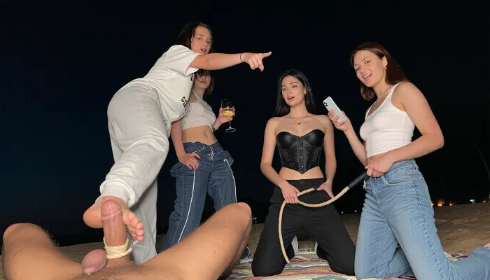3 nerdy girls, 18 years old gen-z amateurs, lesbians, at sleepover party, first girl wearing casual sweatpants and oversized tshirt, second girl wearing fashionable pants and corset, third girl wearing casual wide pants and tank top, (facing viewer), she points her finger ahead, footjob, feet stomping his dick, tied dick, dick torture, cbt, tied balls, one foot on his penis, dick bondage, tied genitals, femdom, sadistic, view from below, pov, she stand on his dick, they on beach on blanket, two girl sits, one girls standing, one girl holds glass of vine, second girl holds whip, third girl holds iphone 15, confident look, night, dark, weak flash, first girl stomping his dick, second girl pulling his Leash, third girl laugh, overexposed, different height, dominant girls, bitchy confident faces, popular girls vibe, hyper realistic