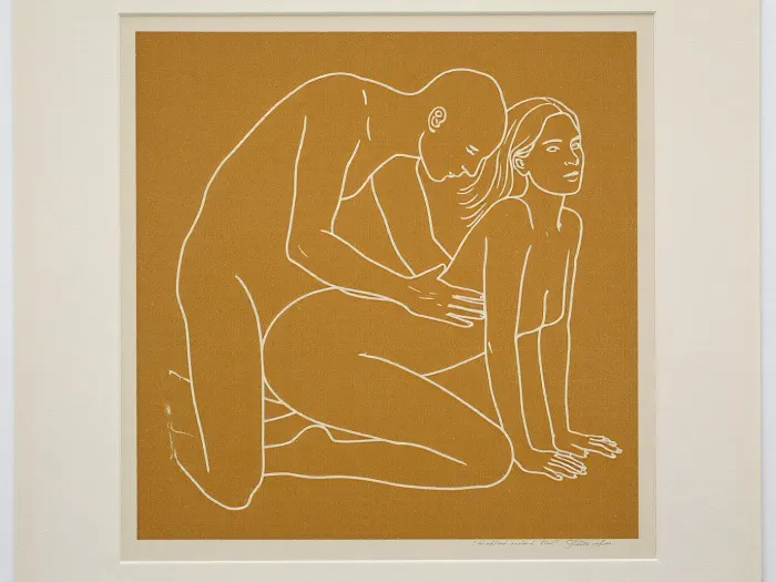 minimalist contemporary figurative screen print, square mustard ochre field centered on a slightly larger pale off white sheet of paper, perfectly frontal reproduction as though photographing a framed or unframed art print straight on, two clearly adult figures, approximately 30 years old, represented exclusively by sparse continuous off white contour lines, intimate but non graphic physical interaction, adult woman positioned on the right in a kneeling all fours pose, knees resting toward the lower center, lower legs extending backward toward the left, arms straight and supporting her upper body, hands placed near the lower right corner, torso gently arched upward, head lifted and turned slightly upward toward the right, long hair suggested with three or four sweeping white lines, second adult figure positioned immediately behind and slightly above her on the left, kneeling upright with torso leaning gently forward, head lowered toward her, arms reaching toward her waist and hips, figures communicating closeness through posture without explicit anatomical detail, facial features reduced to tiny economical marks, absolutely no realistic skin, no shading and no internal modeling, lines approximately uniform in thickness with occasional hand drawn irregularity, muted mustard yellow ochre background with subtle screen print texture, warm ivory white linework, large calm areas of untouched color surrounding the figures, composition centered slightly below the vertical midpoint, recognizable human anatomy simplified into elegant flowing contours, late twentieth century graphic art aesthetic, restrained provocative museum print character, thin pale paper border visible around the mustard square, tiny nearly illegible artist signature near the lower right margin, soft neutral ambient illumination, slight paper texture, perfectly square presentation.